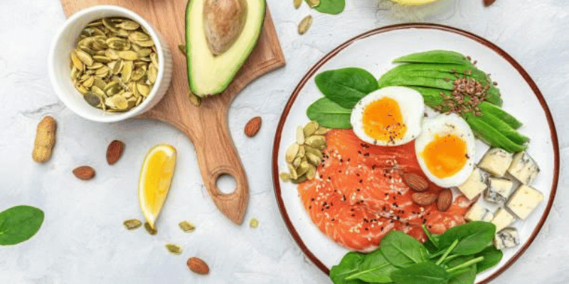 Set of diet food, salmon, avocado, cheese, egg, spinach and nuts on a light background. banner, menu, recipe place for text, top view