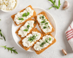 healthy and tasty snack with crispy bread, cottage cheese and herb - cottage cheese