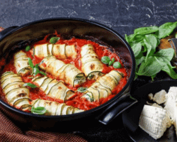 zucchini rollatini stuffed with fresh italian soft cheese ricotta with baby spinach and basil leaves